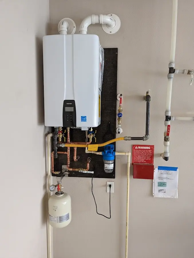 Professional plumber installing copper piping in a Freehold home